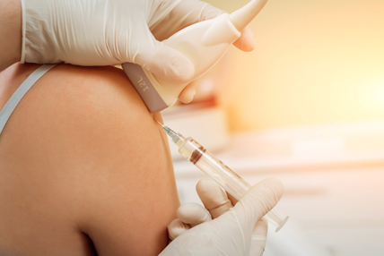 Doctor conducting ultrasound exam of patient's shoulder